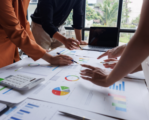 Side view of financial team analyzing charts and graphs