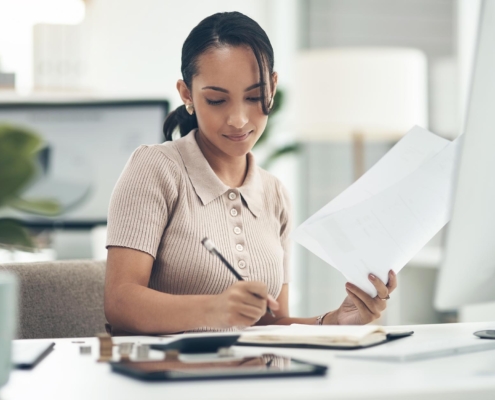 Person in office at desk looking at paperwork