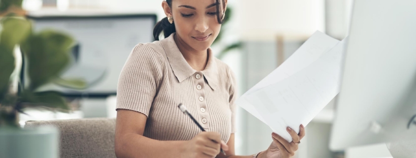 Person in office at desk looking at paperwork