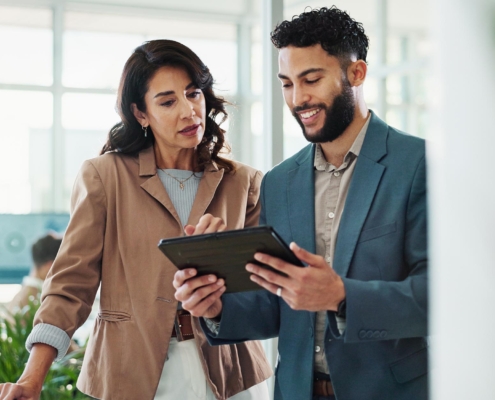 Two people talking in office