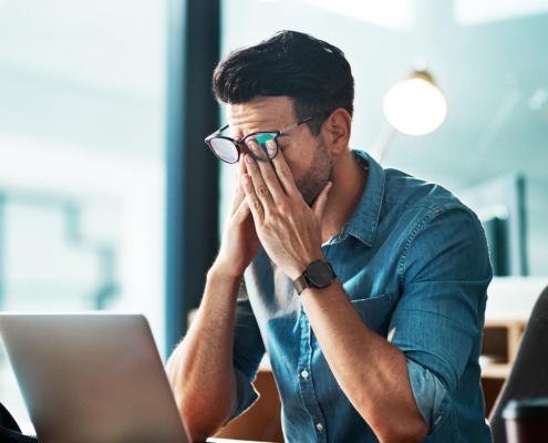 Worker stressed at computer