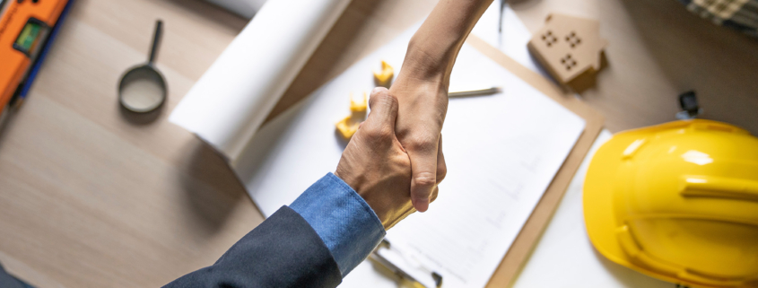 Owner of home shaking hands after architect build home finish