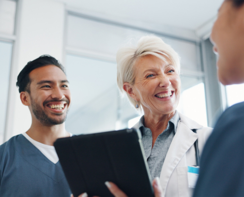 Doctor, team and tablet in discussion with senior for healthcare training